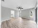 Spacious bedroom with wood-look floors, ceiling fan, and access to bathroom at 2675 Cherokee St, North Port, FL 34286