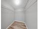 Walk-in closet includes built-in shelving, lighting, and durable wood-look flooring at 2675 Cherokee St, North Port, FL 34286
