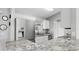 Modern kitchen with stainless steel appliances and granite countertops offers a stylish cooking space at 2675 Cherokee St, North Port, FL 34286