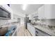 Bright kitchen features stainless steel appliances, white cabinetry, and granite countertops at 2675 Cherokee St, North Port, FL 34286