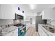 Bright kitchen boasts granite countertops, updated appliances, and ample cabinet space at 2675 Cherokee St, North Port, FL 34286