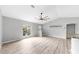 Bright living room with stylish floors, large windows, and modern ceiling fan at 2675 Cherokee St, North Port, FL 34286
