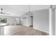 Cozy living room featuring vaulted ceiling, laminate flooring, and neutral paint at 2675 Cherokee St, North Port, FL 34286