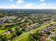 Aerial view of a residential neighborhood with tree-lined streets and well-maintained homes at 2808 Abbey Grove Dr, Valrico, FL 33594
