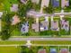 Overhead shot of property showing a fenced backyard, mature trees, and a neatly landscaped lawn at 2808 Abbey Grove Dr, Valrico, FL 33594