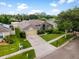 Beautiful home featuring a large driveway, verdant lawn, and mature trees in a desirable neighborhood setting at 2808 Abbey Grove Dr, Valrico, FL 33594