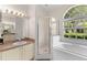 Relaxing bathroom featuring a large tub, a shower, and natural light at 2808 Abbey Grove Dr, Valrico, FL 33594