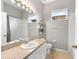 Bright bathroom with neutral color palette, window, and shower/tub combo at 2808 Abbey Grove Dr, Valrico, FL 33594