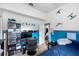 bedroom with blue accent wall, TV, desk, and Star Wars-themed decor at 2808 Abbey Grove Dr, Valrico, FL 33594