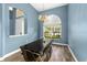 The dining room is painted a calming blue, and has a window to let in light and see the landscape at 2808 Abbey Grove Dr, Valrico, FL 33594
