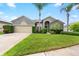 Charming single-story home boasts lush landscaping, a well-manicured lawn, and a welcoming facade at 2808 Abbey Grove Dr, Valrico, FL 33594