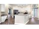 Bright kitchen with white cabinets, stainless steel appliances, and tile flooring at 2808 Abbey Grove Dr, Valrico, FL 33594