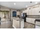 Bright kitchen featuring wood-look tile, stainless steel appliances, and generous countertop space with an open layout at 2808 Abbey Grove Dr, Valrico, FL 33594