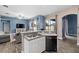 Modern kitchen with a double sink, stainless steel dishwasher, and breakfast bar overlooking the open floor plan at 2808 Abbey Grove Dr, Valrico, FL 33594