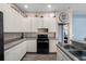 Updated kitchen featuring white cabinets, granite countertops, stainless steel appliances, and a gas range at 2808 Abbey Grove Dr, Valrico, FL 33594