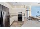 Bright kitchen featuring white cabinets, granite countertops, and stainless steel appliances at 2808 Abbey Grove Dr, Valrico, FL 33594