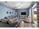 Comfortable living room with hardwood floors, a ceiling fan, and sliding glass doors that offer natural light at 2808 Abbey Grove Dr, Valrico, FL 33594