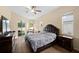 Bedroom featuring a large bed, dark wood dresser, and sliding glass doors leading to a screened patio at 2808 Abbey Grove Dr, Valrico, FL 33594