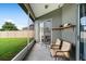 Cozy screened patio with comfortable seating, overlooking a well-maintained fenced backyard at 2808 Abbey Grove Dr, Valrico, FL 33594