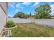 Well-maintained backyard enclosed by a white fence with block planters and green landscaping at 3035 Annadale, Brandon, FL 33511