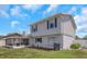 Exterior view of the backyard featuring a screened-in patio, with a glimpse of the chimney and windows at 3035 Annadale, Brandon, FL 33511