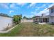 Large, fenced backyard featuring a screened-in porch with lush landscaping and block planters at 3035 Annadale, Brandon, FL 33511