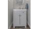 Small bathroom with a gray vanity and a round mirror at 3035 Annadale, Brandon, FL 33511