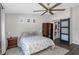Bedroom featuring a ceiling fan, neutral walls, wooden floors, and a closet with a sliding barn door at 3035 Annadale, Brandon, FL 33511