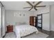 Bedroom featuring a ceiling fan, neutral walls, wooden floors, and a closet with a sliding barn door at 3035 Annadale, Brandon, FL 33511