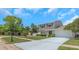 Charming two-story home with a well-manicured lawn, mature trees, and a long driveway at 3035 Annadale, Brandon, FL 33511