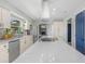 This kitchen features a white island with cooktop, stainless appliances, white cabinets and lots of countertop space at 3035 Annadale, Brandon, FL 33511