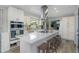 Modern kitchen features a center island with a sleek cooktop and seating, perfect for culinary enthusiasts at 3035 Annadale, Brandon, FL 33511
