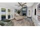 Cozy living room with a brick fireplace, large windows, and neutral-toned furniture at 3035 Annadale, Brandon, FL 33511