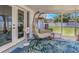 Relaxing screened-in patio featuring a cozy egg chair and garden-themed rug, perfect for enjoying the outdoors at 3035 Annadale, Brandon, FL 33511