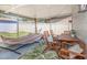 Covered patio featuring a hammock, outdoor seating, and leafy rug perfect for relaxing and entertaining in the backyard at 3035 Annadale, Brandon, FL 33511