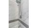 Close-up of the modern shower with dual shower heads, marbled tiling, and contrasting mosaic trim that is sure to please at 3035 Annadale, Brandon, FL 33511