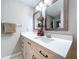 Bathroom vanity featuring double mirrors, modern fixtures, and neutral decor at 30456 Willow Bank Ave, Brooksville, FL 34602