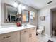 Bathroom with double vanity, modern fixtures, and framed mirrors at 30456 Willow Bank Ave, Brooksville, FL 34602