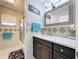 Bathroom with modern vanity, decorative mirror, stylish tile accent, and glass shower enclosure at 30456 Willow Bank Ave, Brooksville, FL 34602