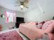 Bedroom featuring pink decor, ceiling fan, window, and a plush rug at 30456 Willow Bank Ave, Brooksville, FL 34602