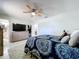 Bright bedroom featuring a ceiling fan, neutral walls, and a large dresser with a TV on top at 30456 Willow Bank Ave, Brooksville, FL 34602