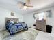 Cozy bedroom featuring blue accents, natural light, and updated floors at 30456 Willow Bank Ave, Brooksville, FL 34602