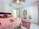 Bedroom with pink decor, ceiling fan, white walls, closet, and a plush rug at 30456 Willow Bank Ave, Brooksville, FL 34602