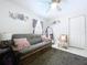 Bedroom featuring modern ceiling fan, a comfortable futon, stylish decor, and a large rug at 30456 Willow Bank Ave, Brooksville, FL 34602