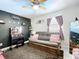 Cozy bedroom featuring a futon, a makeup vanity, modern fixtures, and stylish decor at 30456 Willow Bank Ave, Brooksville, FL 34602