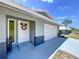 Charming single-story home with a brick accent, a white door with wreath, and a spacious garage at 30456 Willow Bank Ave, Brooksville, FL 34602