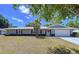 Charming single-story home with a well-manicured lawn and metal roof, perfect for curb appeal at 30456 Willow Bank Ave, Brooksville, FL 34602
