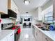 Open kitchen featuring white cabinets, black appliances, and views to the dining and living room at 30456 Willow Bank Ave, Brooksville, FL 34602