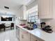 Bright kitchen featuring white cabinets, quartz countertops, and views to the dining room at 30456 Willow Bank Ave, Brooksville, FL 34602