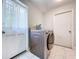 Laundry room equipped with modern washer/dryer, a patterned tile floor, and access to the exterior at 30456 Willow Bank Ave, Brooksville, FL 34602